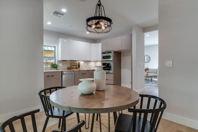 kitchen with stainless steel appliances, light countertops, baseboards, and modern cabinets