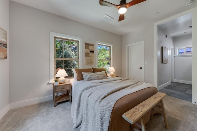 bedroom with baseboards, visible vents, and ceiling fan