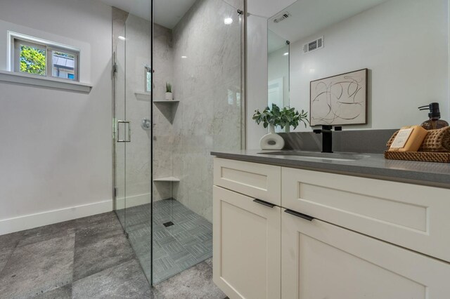 bathroom featuring a shower stall, baseboards, vanity, and visible vents