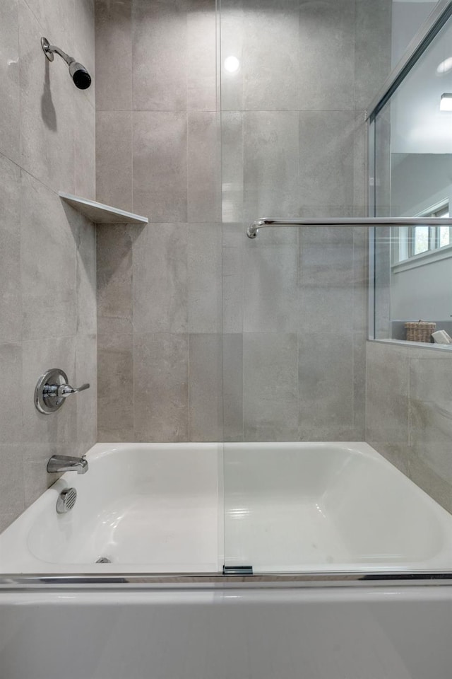 bathroom featuring bath / shower combo with glass door