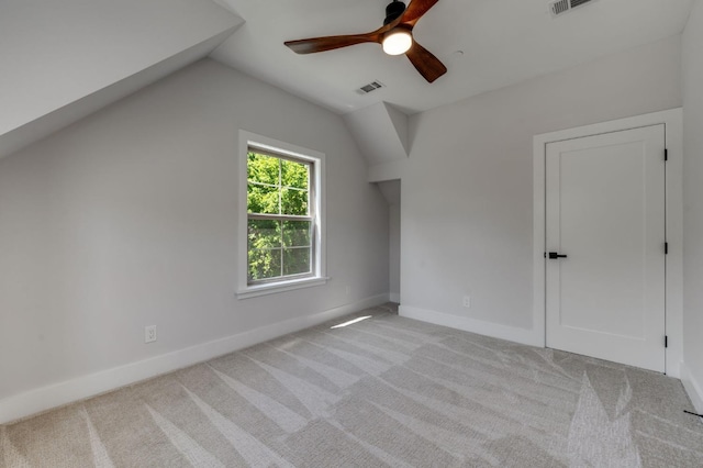 bonus room featuring lofted ceiling, a ceiling fan, baseboards, and carpet
