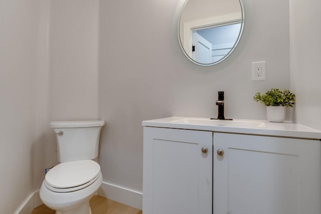 2701 Swanston Oaks, Sacramento, CA 95818 - half bath featuring baseboards, vanity, toilet, and wood finished floors