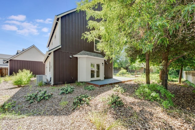 view of outbuilding with fence, french doors, and cooling unit
