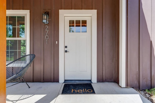view of exterior entry with covered porch