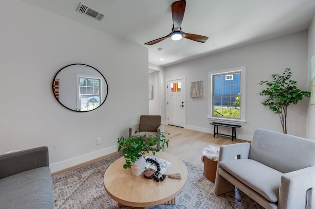 living room featuring wood finished floors, ceiling fan, baseboards, visible vents, and recessed lighting