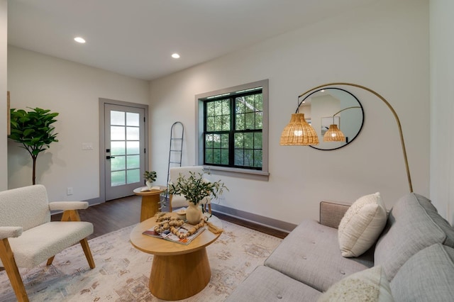 living area with recessed lighting, wood finished floors, and baseboards