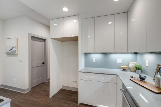 kitchen featuring modern cabinets, white cabinets, dark wood-type flooring, and light countertops