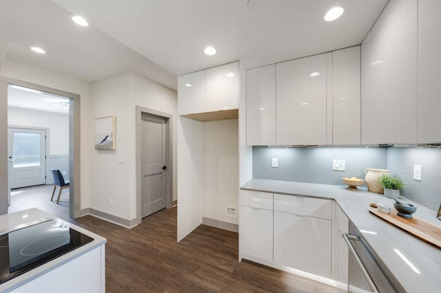 kitchen featuring white cabinets, modern cabinets, light countertops, and dark wood-style flooring