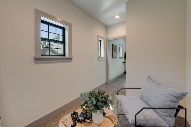corridor with carpet flooring and baseboards