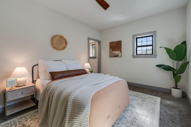 carpeted bedroom with a ceiling fan and baseboards