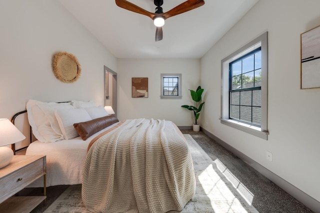 carpeted bedroom with baseboards and a ceiling fan
