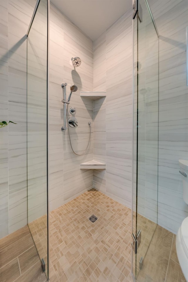 full bath with a shower stall and toilet