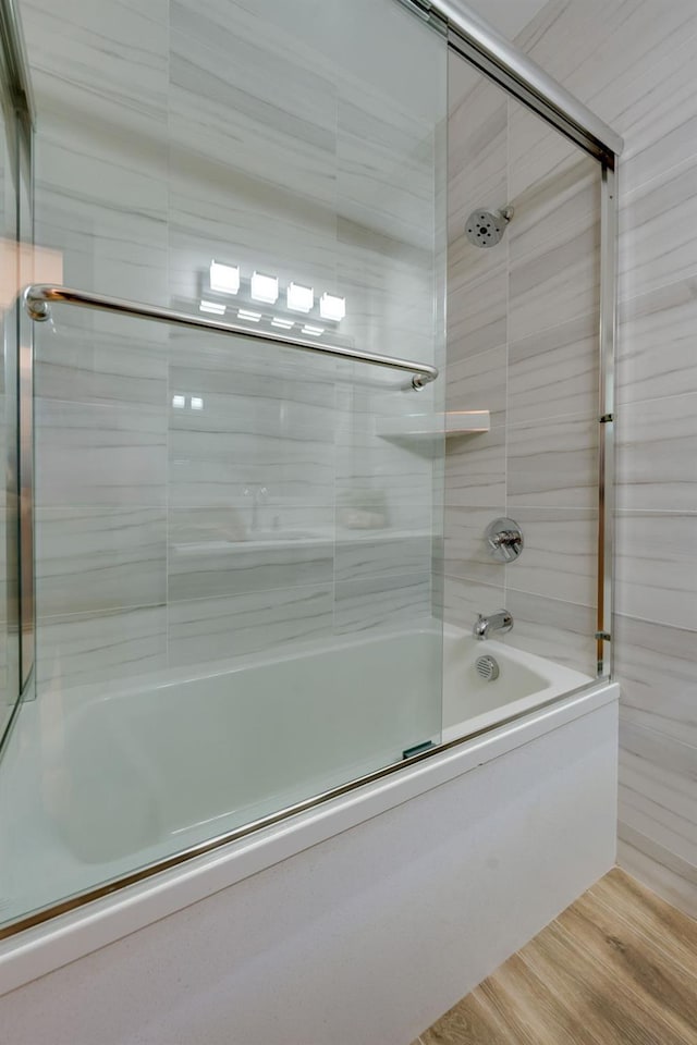 bathroom featuring bath / shower combo with glass door