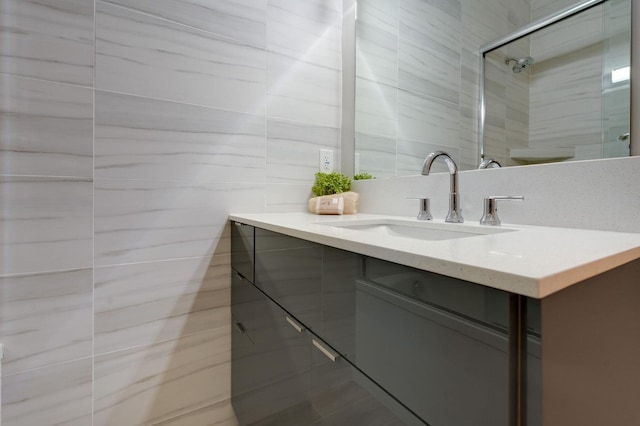 full bath featuring tile walls, vanity, and tiled shower