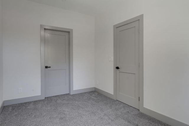 carpeted spare room with baseboards