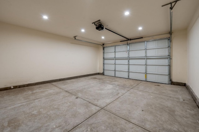 garage featuring recessed lighting, baseboards, and a garage door opener