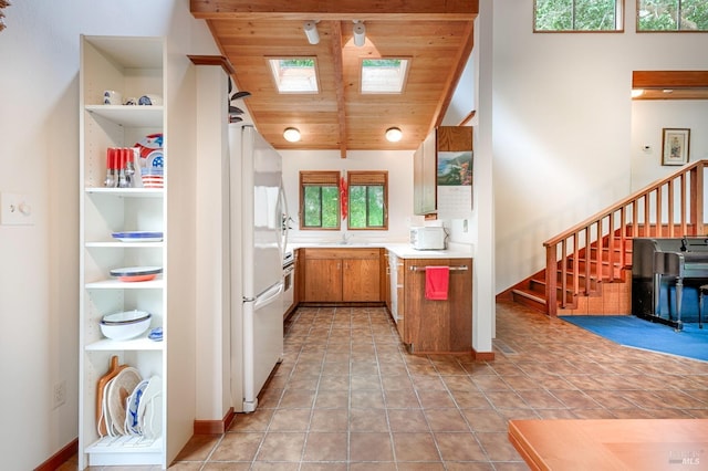 2 Pine Flat Rd, Cazadero, CA 95421 - kitchen with a sink, brown cabinetry, wood ceiling, light countertops, and freestanding refrigerator