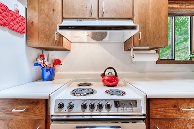 2 Pine Flat Rd, Cazadero, CA 95421 - kitchen featuring brown cabinetry, range with electric stovetop, light countertops, and exhaust hood