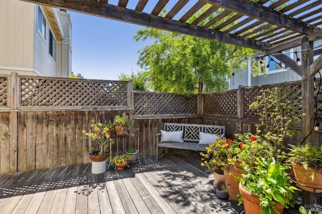 wooden terrace with a pergola and fence