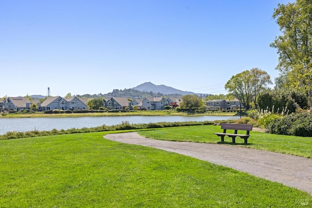 view of community with a lawn, a water and mountain view, and a residential view