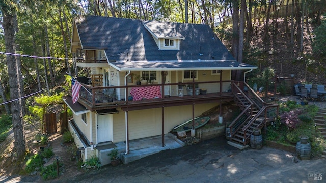 back of property featuring stairs