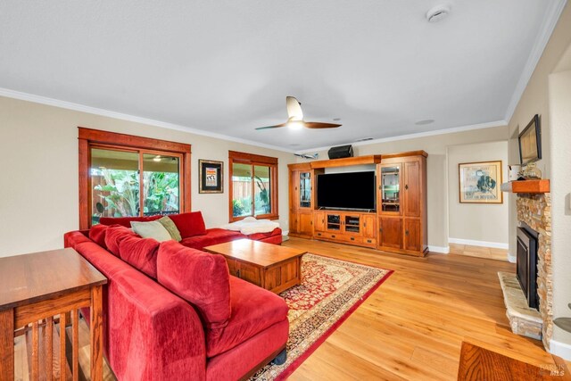 4575 Avondale Cir, Fairfield, CA 94533 - living room featuring light wood finished floors, crown molding, ceiling fan, a stone fireplace, and baseboards