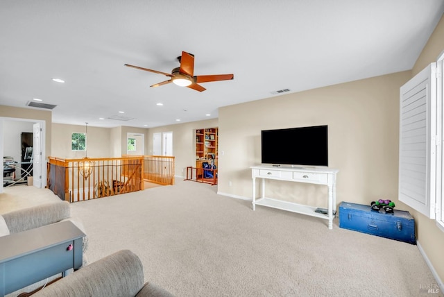 living room with carpet, visible vents, a ceiling fan, and recessed lighting