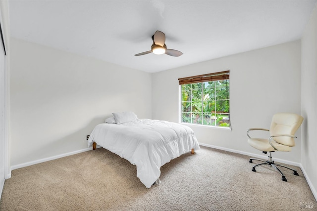 carpeted bedroom with baseboards and a ceiling fan