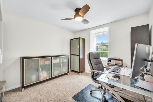 home office with carpet flooring, ceiling fan, and baseboards