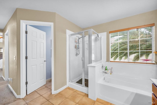 full bath with tile patterned floors, baseboards, a stall shower, and a bath