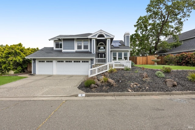 3 Woodgate Pl, Novato, CA 94945 - view of front of home featuring concrete driveway, solar panels, a chimney, an attached garage, and a shingled roof