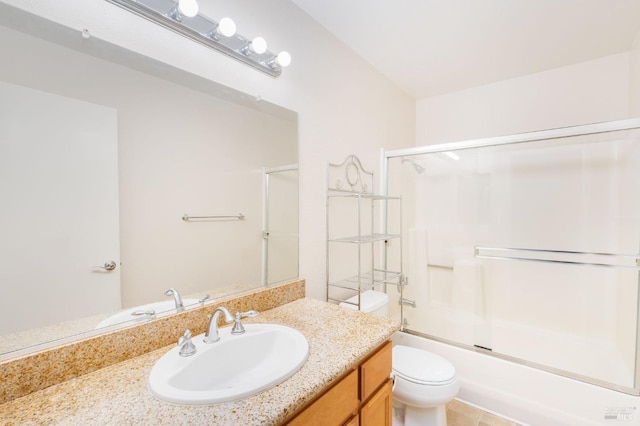 bathroom featuring vanity, shower / bath combination with glass door, and toilet