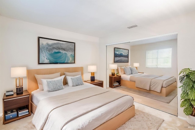 carpeted bedroom with baseboards and visible vents