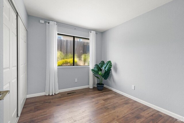 bathroom featuring visible vents, a sink, wood finished floors, and two vanities