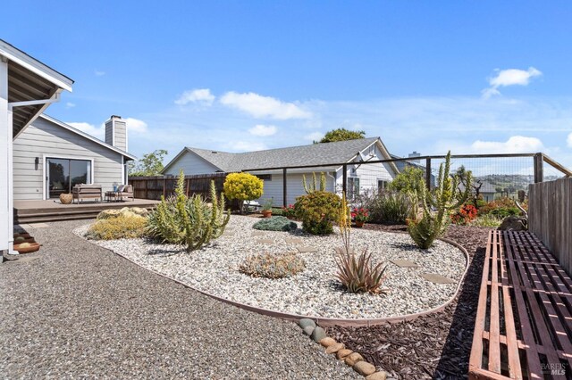 wooden terrace with a fenced backyard