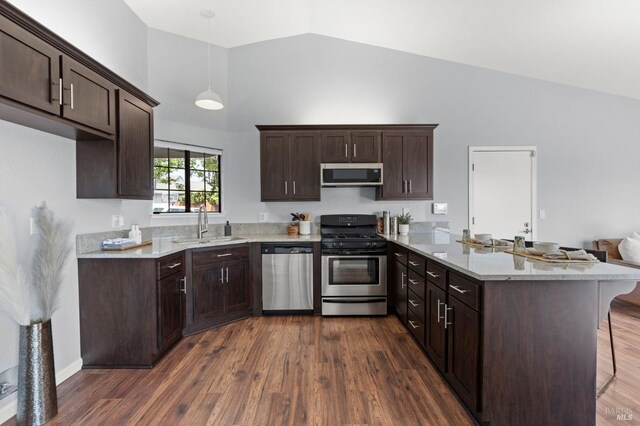 kitchen with dark brown cabinetry, a sink, stainless steel microwave, a peninsula, and black gas range