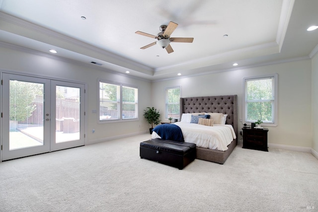 carpeted bedroom with a tray ceiling, access to exterior, visible vents, crown molding, and baseboards
