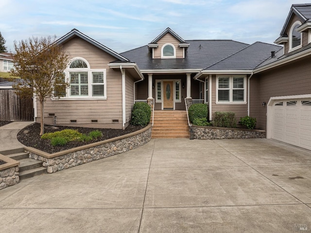 view of front of property with an attached garage, crawl space, driveway, and covered porch
