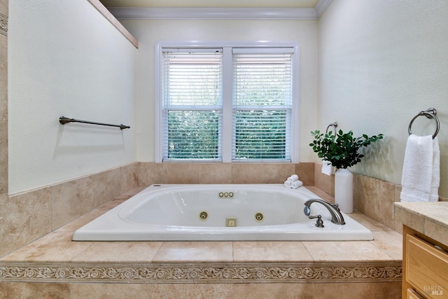 full bath featuring ornamental molding, vanity, and a whirlpool tub
