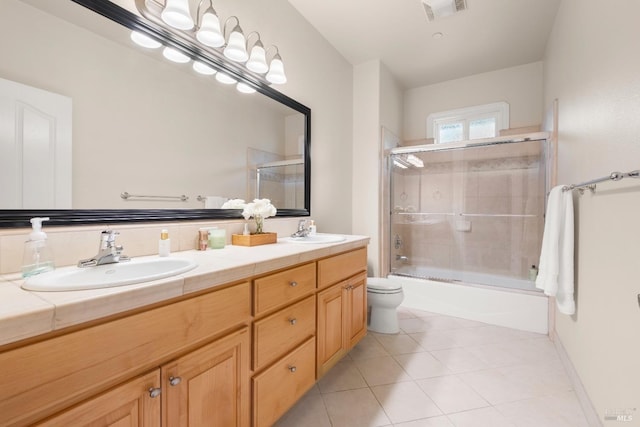 bathroom with tile patterned floors, visible vents, a sink, and double vanity