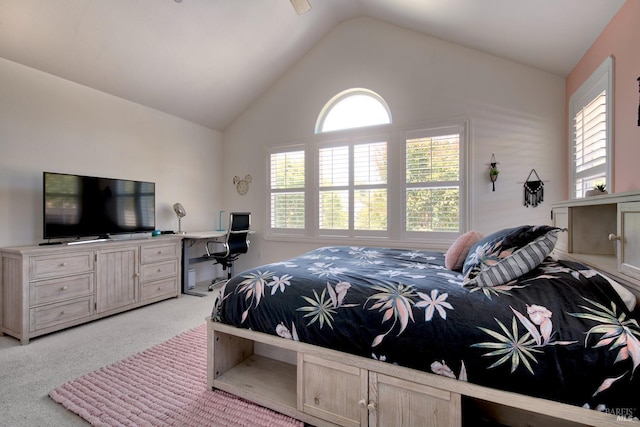 bedroom with lofted ceiling and light colored carpet
