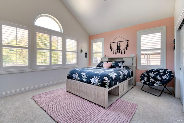carpeted bedroom with lofted ceiling and baseboards
