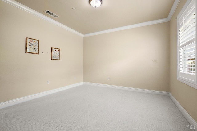 empty room with crown molding, visible vents, carpet flooring, and baseboards