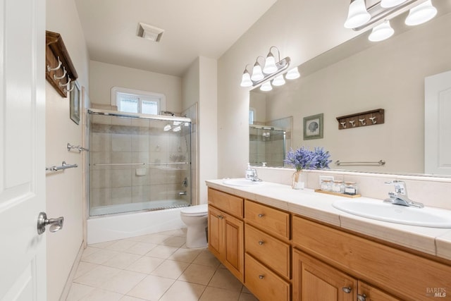 full bath featuring tile patterned flooring, a sink, double vanity, and toilet