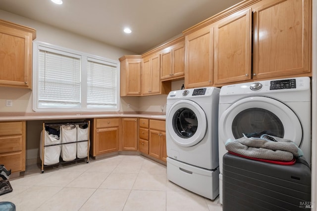 washroom featuring washing machine and clothes dryer, light tile patterned flooring, recessed lighting, and cabinet space
