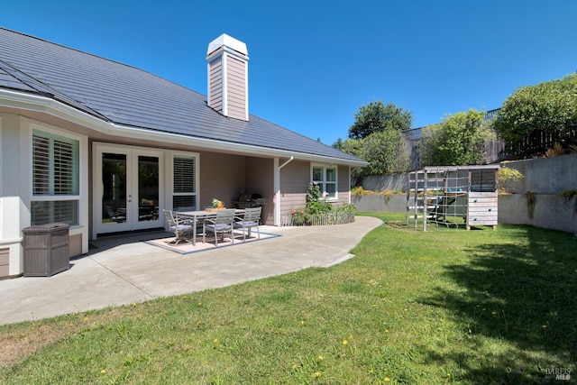 exterior space featuring fence, a patio area, and french doors