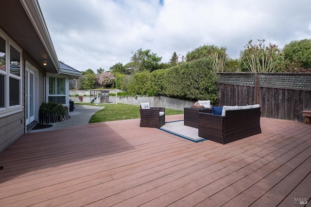 wooden deck with a yard, an outdoor hangout area, and a fenced backyard
