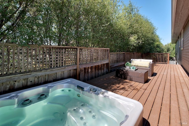 deck with outdoor lounge area and hot tub deck surround