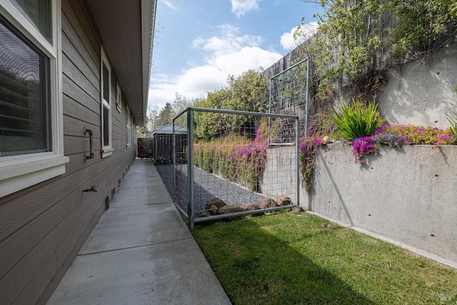 view of side of home with an outdoor structure, a shed, crawl space, and fence