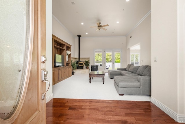 living room featuring a ceiling fan, ornamental molding, french doors, and wood finished floors